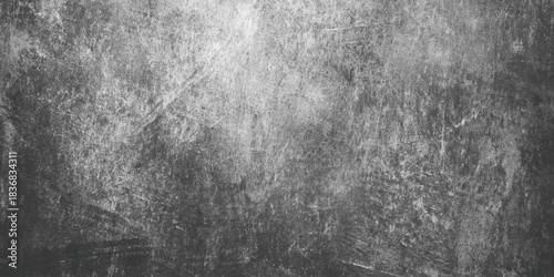 Dark moody grunge texture with scratches cracks and worn concrete surface black and white distressed background.
