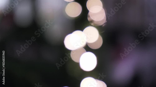 festive party lighting with multicolored bokeh lights forming tree silhouette and animated shimmer