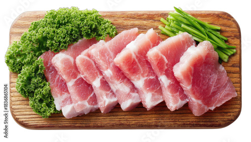 Slices of raw meat arranged on a wooden board with green garnish