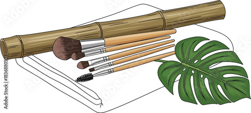 Makeup Brushes with Bamboo Case on White Towel and Monstera Leaf