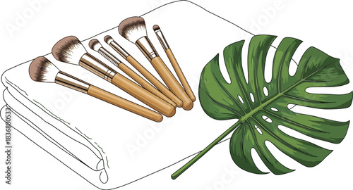 Makeup brushes on a towel with monstera leaf, beauty and wellness concept