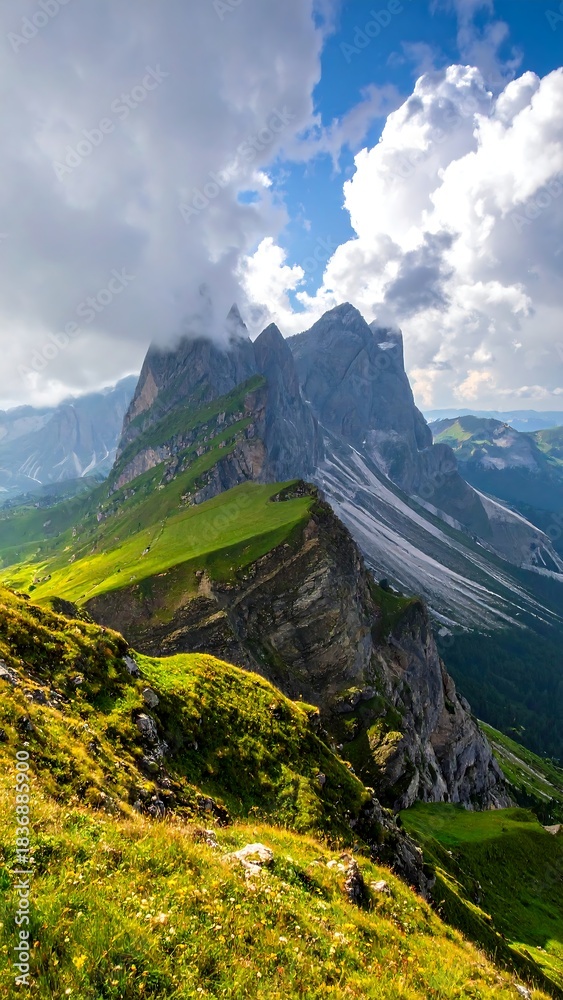 Fototapeta premium Verdant mountain ridge under dramatic clouds, sunny with green landscape