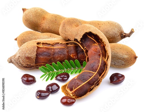 Close-up studio shot featuring several brown, oblong-shaped fruits, some open, revealing a pulpy interior, with seeds