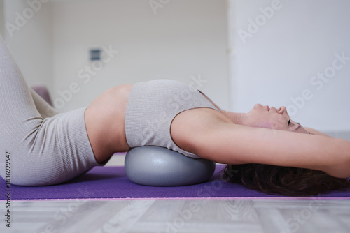 Pilates back stretch exercise ball workout woman training spine flexibility