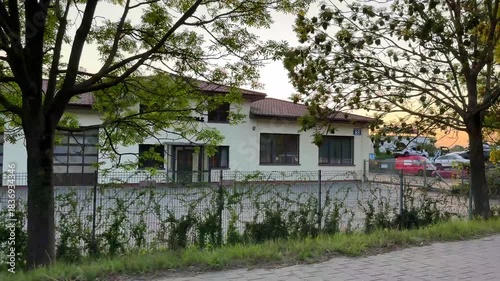 Warsaw, Poland - August 28, 2025: Sunset view over an automotive yard with parked cars, camera pans across the scene, showcasing the tranquil evening atmosphere and surroundings