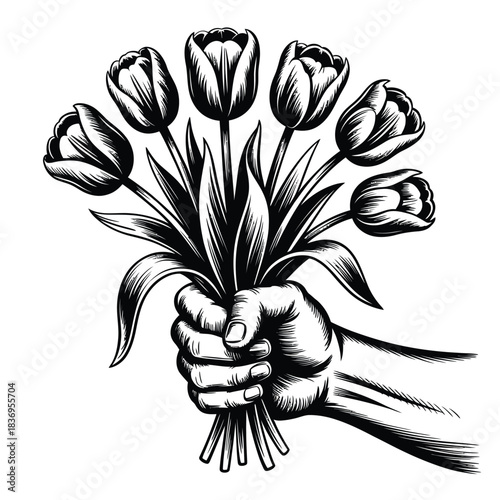 A hand gently holding a beautiful bouquet of blooming tulips