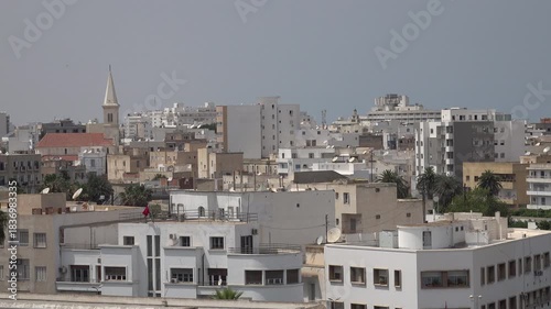 Small church and residential apartment buildings in modern part of Sousse, religion and architecture in Tunisia