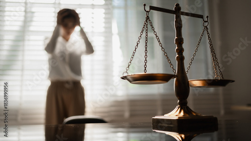 Schilderij op canvas The scales of justice stand in focus while a woman seeks counsel, symbolizing the legal protection of women's rights, gender equality, safety from domestic violence, and the pursuit of fair justice