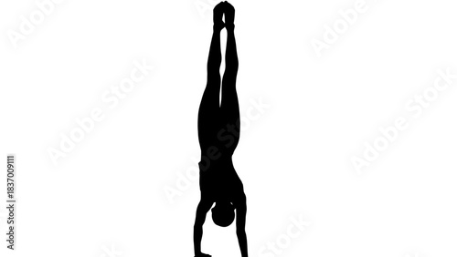 Silhouette of a person performing a handstand with perfect balance.