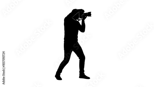 Silhouette of a photographer capturing a moment with a camera.