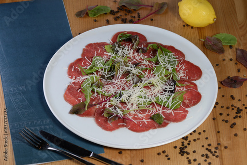 veal earpacho on a plate with cheese and arugula