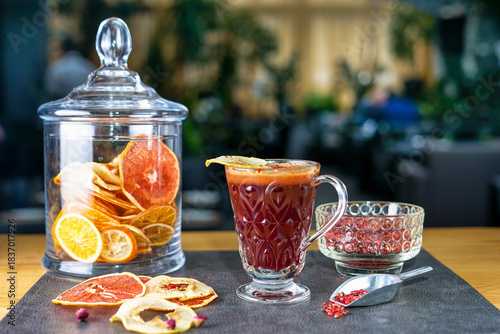 mulled wine in a transparent cup on a table with decor