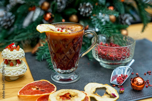 mulled wine in a transparent cup on a table with decor
