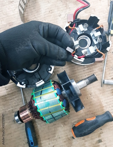 Electric motor in the hands of a worker. The concept of repair and maintenance.