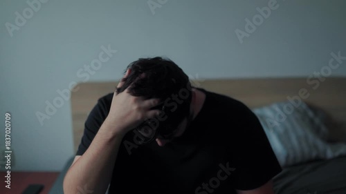 Tired man waking up slowly in the morning and reacting groggy after sleep