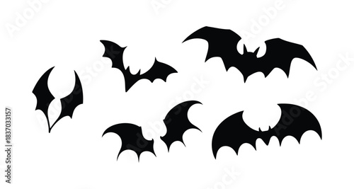 Collection of silhouetted flying bats on white background 