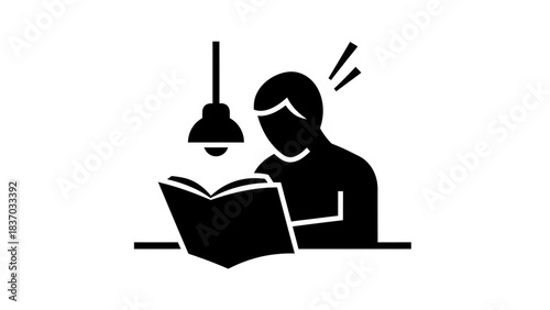 Black silhouette of a person reading a book under a desk lamp, symbolizing study, concentration, and knowledge acquisition.