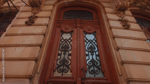 vintage wooden door, the entrance to a retro building on a sunny street. The camera zooms in on the old door.