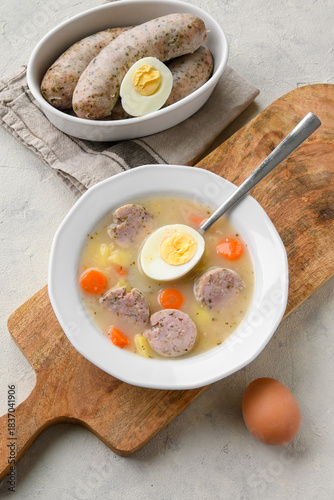 Sour soup with sausage and egg, traditional Polish soup