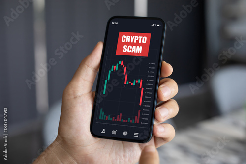 Wallpaper Mural man hand hold phone with chart scam crypto coins screen Torontodigital.ca