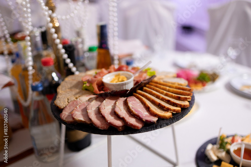 Fancy meat platter with various cuts and dips at a celebratory event