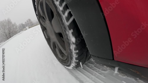 Car wheel slides on snow demonstrating ABS braking in winter conditions