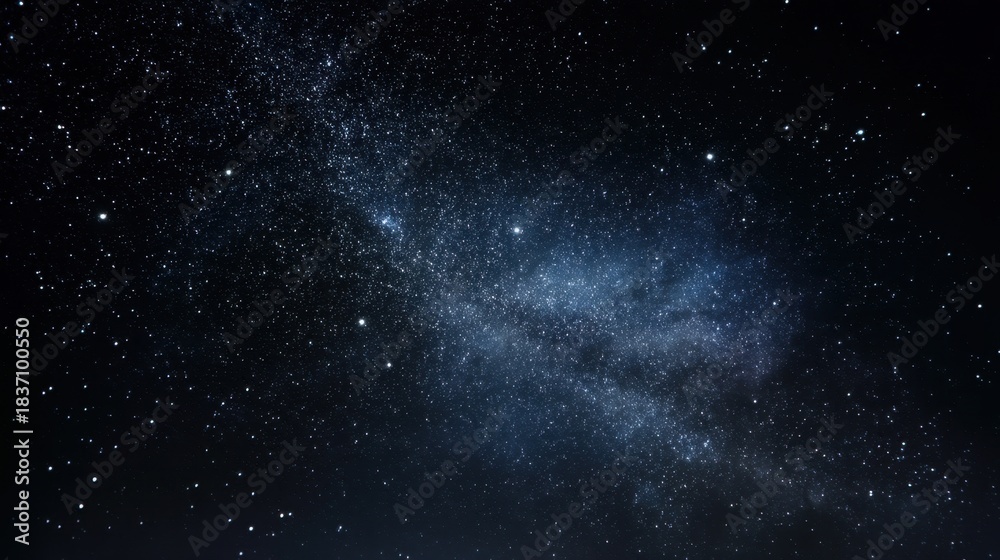 Obraz premium Bright stars and distant galaxies fill the night sky above. The dark landscape below contrasts with the shimmering celestial bodies. It is a clear evening perfect for stargazing.