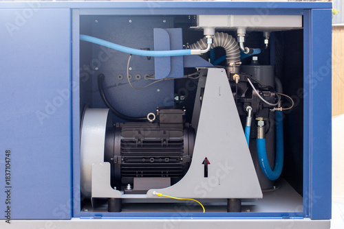 Fotografija modern industrial screw air compressor cabinet, showcasing the electric motor, c