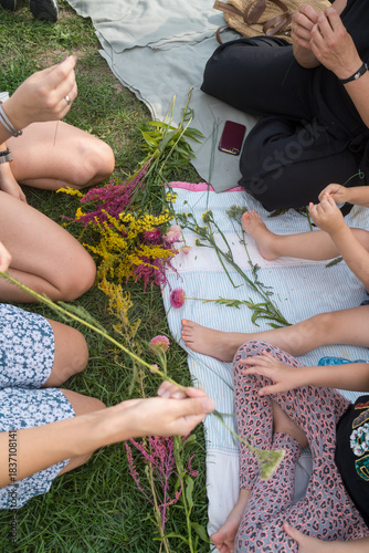 Woman making traditional flower crown with wild flowers for midsummer celebration or bridal party