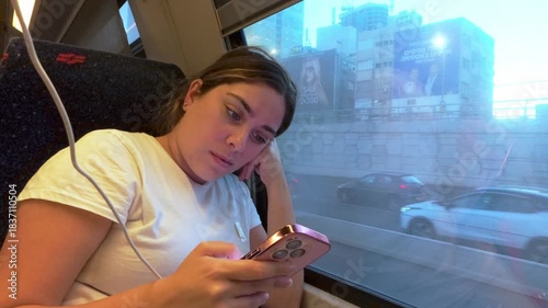 Woman Face Lit by Phone Screen with Reflection in Window