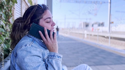 Serene Woman on a Phone Call at an Empty Train Station