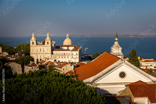 Schilderij op canvas Vista panorámica de la zona histórica de Lisboa (Portugal) con cúpulas y campanarios en primer plano y el estuario del Tajo al fondo