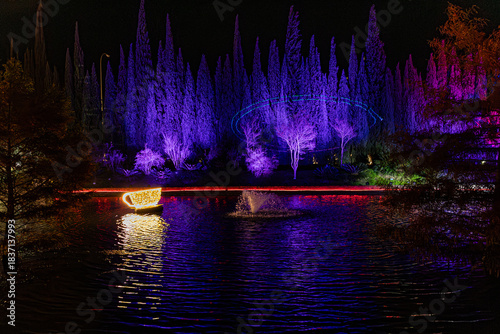 Foto Taza de café gigante luminosa flotando en un lago con reflejos morados y árboles de fantasía
