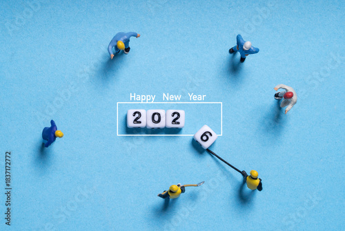 Miniature workers preparing the number blocks for 2026 create a playful scene symbolizing new year readiness progress teamwork planning goals motivation and positive transition toward fresh beginnings