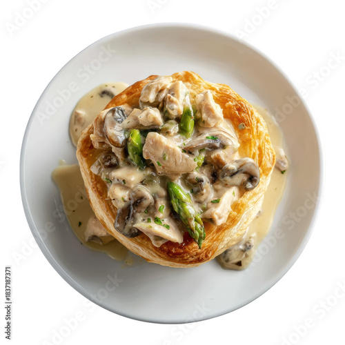 Savory gourmet vol au vent puff pastry filled with rich creamy chicken, mushroom, and asparagus sauce on plate