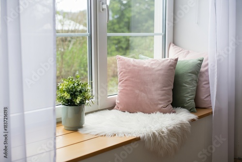 Cozy Window Seat Interior, Faux Fur Cushion, Potted Plant, Natural Light, Home Decor Element, Relaxation Spot, Bright Window Nook Design, Comfortable Seating Area, Modern Home Interior.