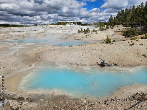 Dramatic clouds over hot springs in Norris Geyser Basin in Yellowstone
