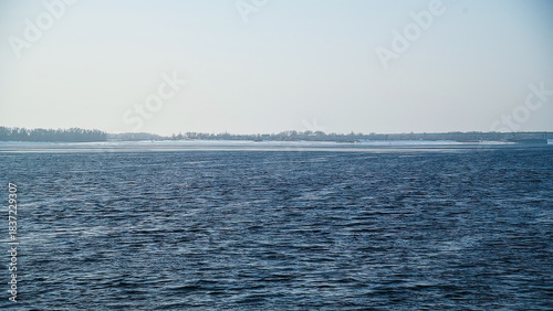 Snow river winter landscape. Frozen ice and snow by river.