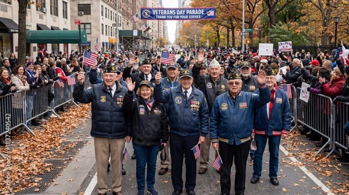 Veterans waving during a parade in autumn with cheering crowd