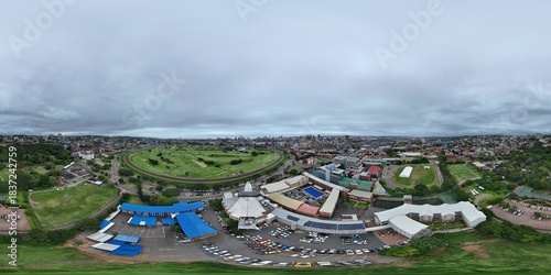 360 aerial photo taken with drone of a primary school, a secondary school, a university, and an events center on overcast day in downtown Durban, South Africa