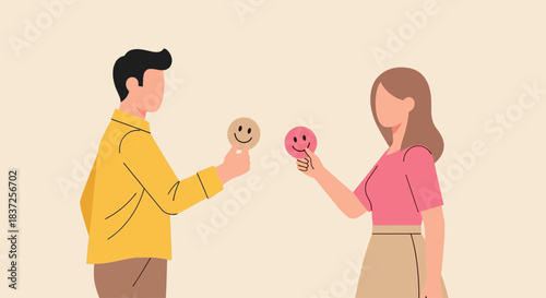 A man and a woman holding up smiley face icons, representing emotions and communication.