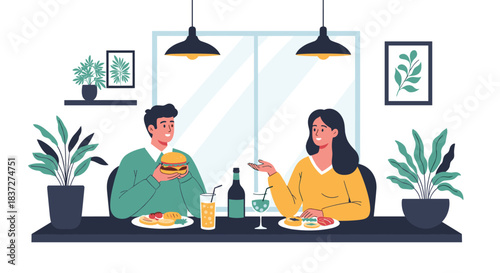 Happy young couple enjoying a dinner date together at a modern restaurant talking and eating their delicious meals.