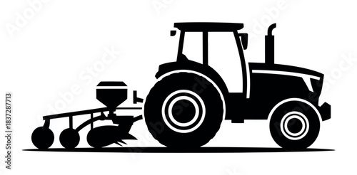 A silhouette of a tractor pulling a planter across a field.