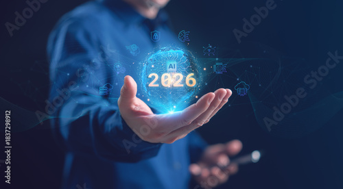 A businessman holding a glowing holographic AI globe with 2026 and artificial intelligence, cloud computing, neural network, and cybersecurity icons, representing future technology. AI trends in 2026.
