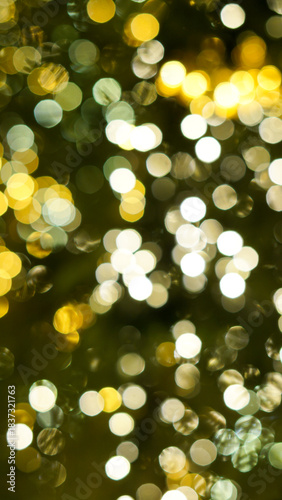 Defocused string lights on christmas tree, shiny gold yellow blurred bokeh circle background wallpaper for festive season celebration. 