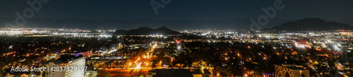 The Night Lights of Downtown Riverside, California from  a UAV Drone Aerial view with the horizon in the background during the Christmas Holiday Season.