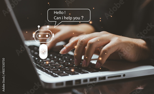 A friendly AI chatbot icon greeting a user typing on a laptop, symbolizing automated support, digital communication, virtual assistance, and intelligent customer service interaction.