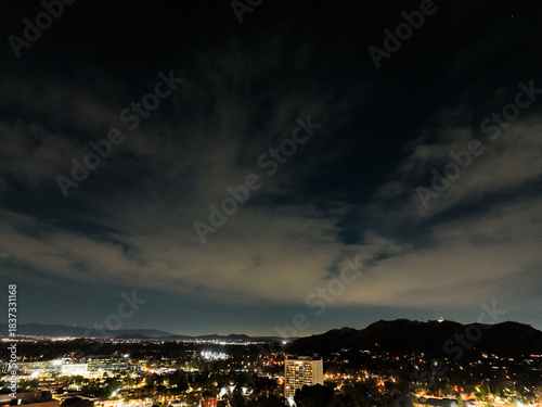 The Night Lights of Downtown Riverside, California from  a UAV Drone Aerial view with the horizon in the background during the Christmas Holiday Season.