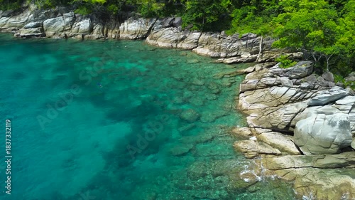 Vacation in Southeast Asia, sea travel in Thailand. Snorkeling near tropical islands. Tourists off the coast of Koh Racha Yai explore the underwater world, as seen from a drone.