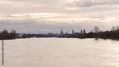 Dresden, Germany during a flood in December 2023. High water levels in the Elbe river. The water is covering the riverbanks and the environment in the floodplain area.